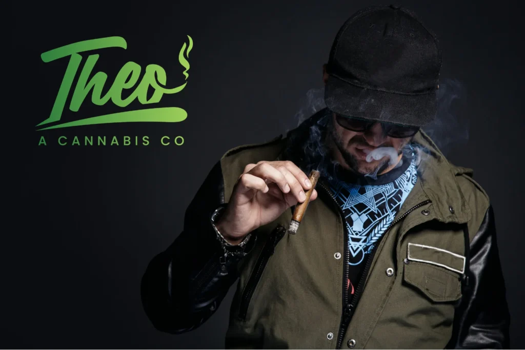 Man smoking a cannabis pre-roll with smoke visible, featured beside the Theo A Cannabis Co logo on a dark background.