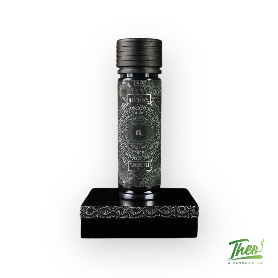 Black pre-roll tube from Niche featuring intricate silver typography and design, labeled with "Pink Ink" strain. Premium cannabis product from Theo Dispensary.