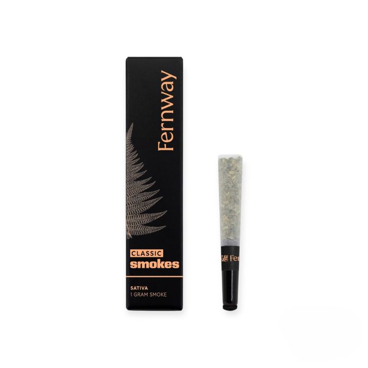 A sleek black box labeled “Fernway Classic Smokes” with copper typography and a fern illustration, shown next to a single 1-gram sativa pre-roll with a black-tipped filter.
