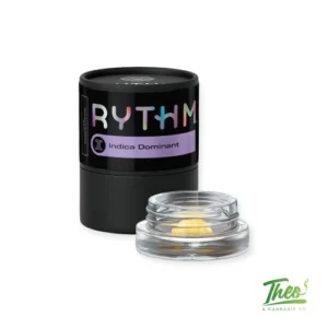 RYTHM indica dominant cannabis concentrate in black container with glass jar of extract, showcasing premium marijuana concentrate product with Theo’s Cannabis Co branding on clean white background.